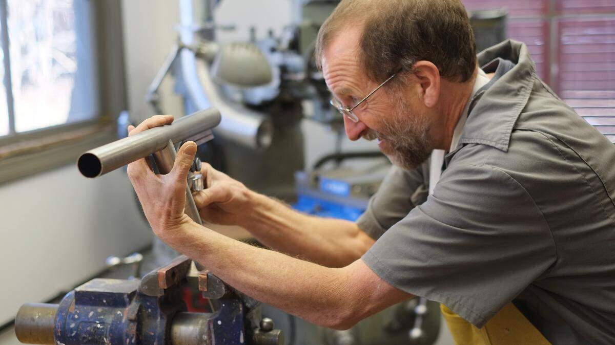Alex Meade checked angles to precisely fit two steel tubes for a bicycle frame he is building for a customer. 