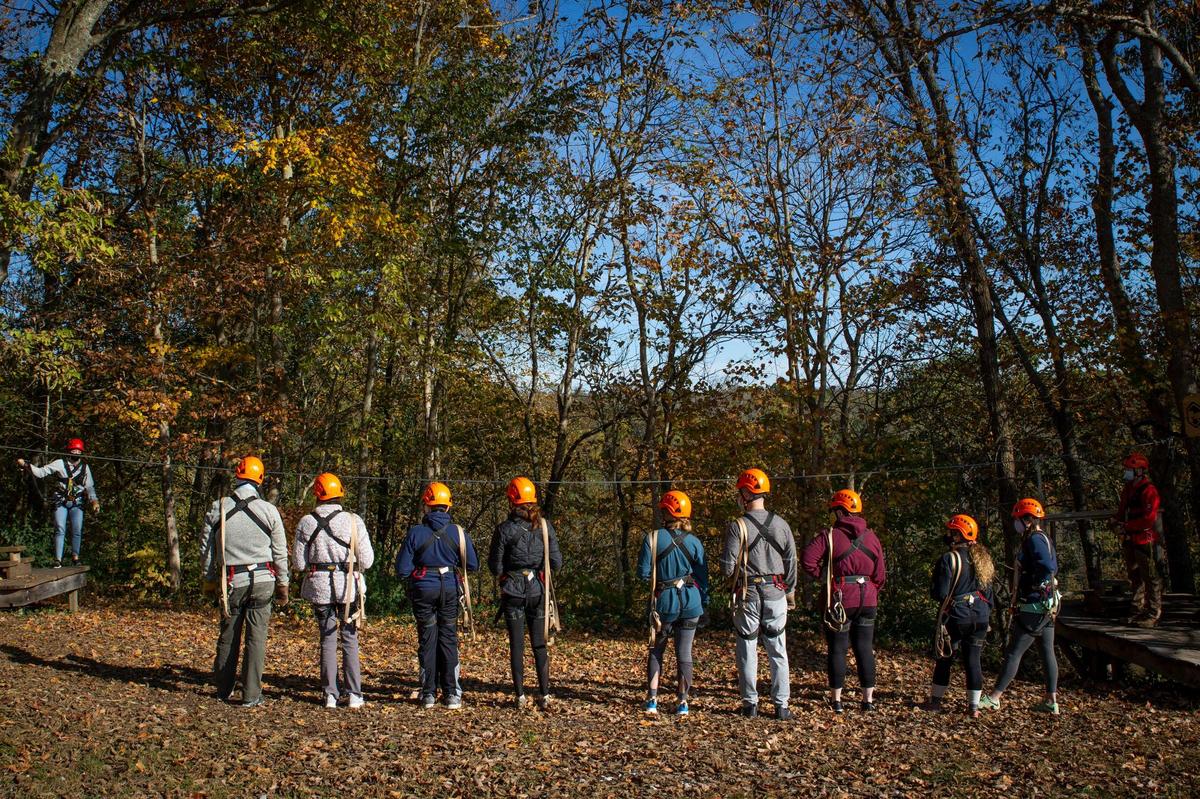 Members the Boone Creek Outdoors Zip Line Canopy Tour participate in “ground school,” where the participants learn the basics of zip lining, before beginning the tour on Saturday, Oct. 17, 2020, in Lexington, Ky. The Canopy Tour includes six zip lines, three sky bridges, a rappel, a spiral, and a floating staircase.