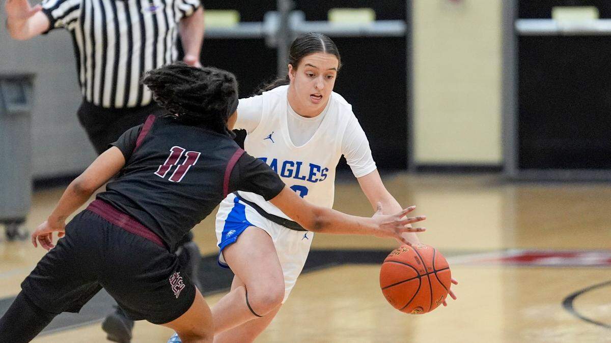 Piper Graham, who scored 17 points for Lexington Christian, drives against Miracle Morbley, who had 18 to lead Tates Creek.