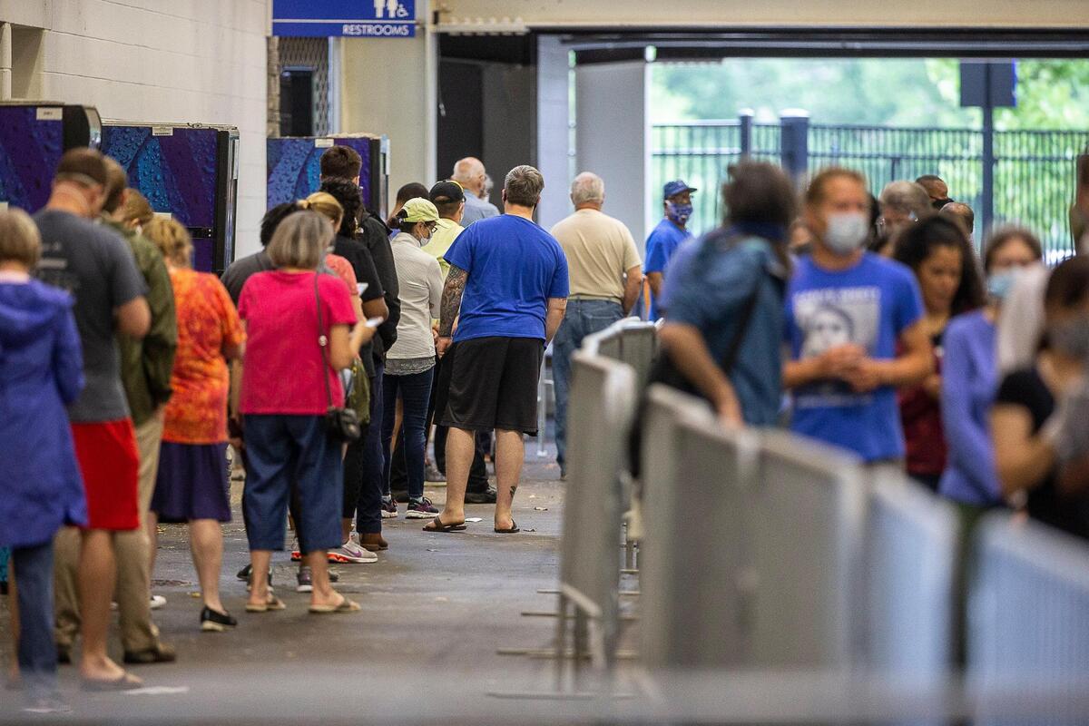 Fayette County voters wait in line to cast their ballots at Kroger Field in Lexington, Ky., on Tuesday, June 23, 2020.