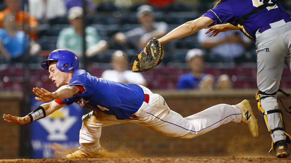 Madison Central’s Bryce Travis dove toward home plate past Bowling Green’s Bo Morton during last season’s state baseball tournament at Whitaker Bank Ballpark in Lexington.