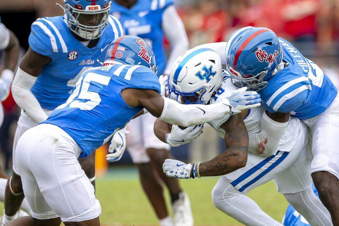 Kentucky running back Jamarion Wilcox (10) is wrapped up by Mississippi linebacker Khari Coleman (23) during Saturday’s game.