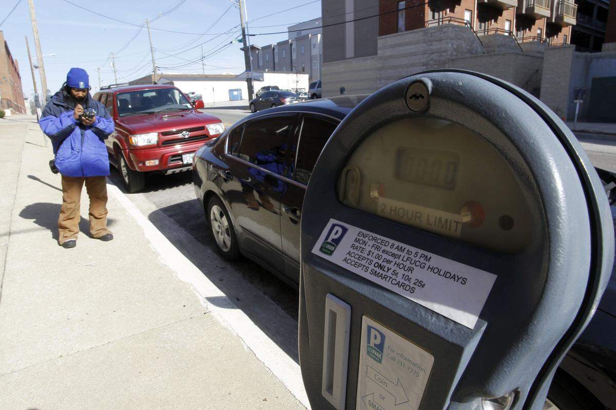 LexPark’s Clarice McDowell issued a citation Friday to a vehicle parked in front of an expired meter on Boliver Street downtown. Since its inception in 2008, the Lexington Parking Authority has become a self-sustaining agency that helps pay for parking improvements and repairs.
