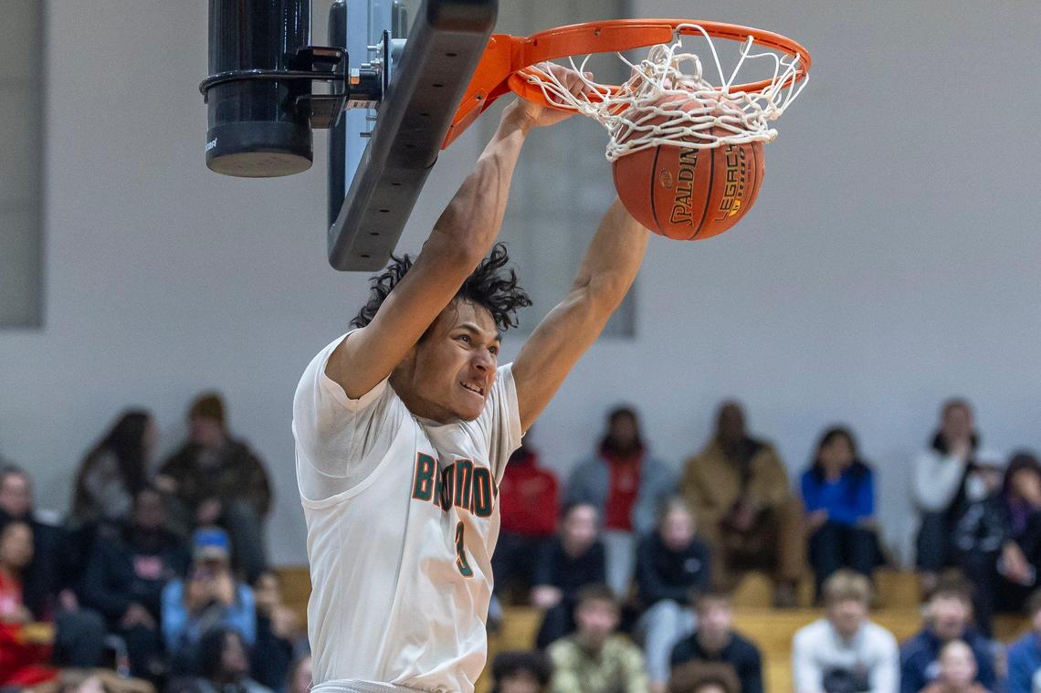 Frederick Douglass’ DeMarcus Surratt (3) dunks the ball on the first play of the second half against Bryan Station at Frederick Douglass High School on Jan. 15.