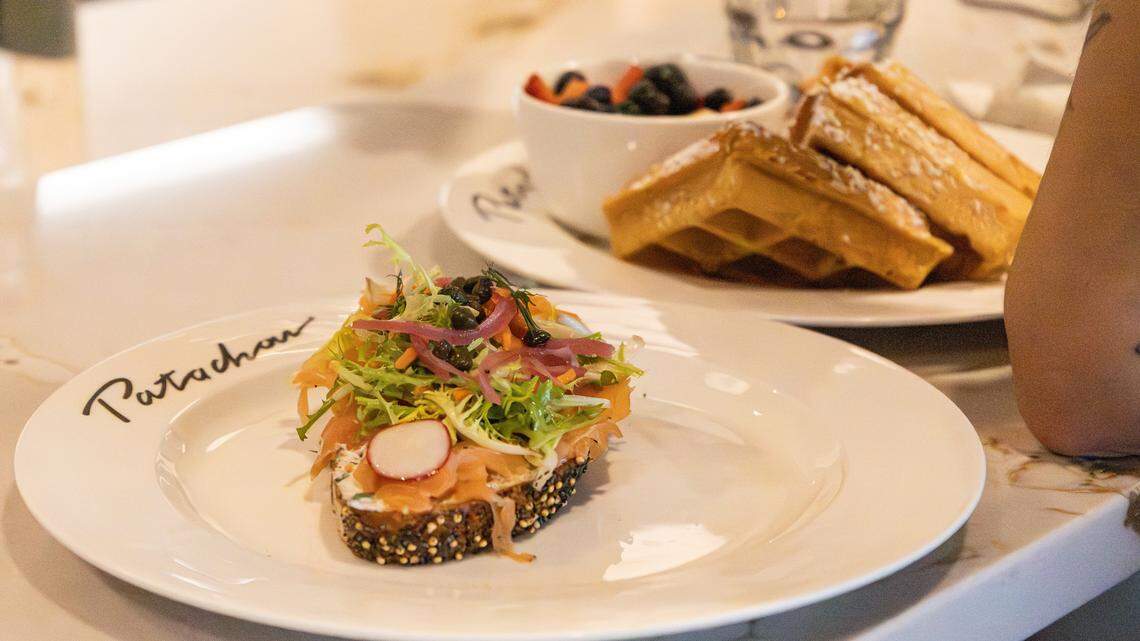 Salmon with capers and waffles dusted with powdered sugar are just some of the lunch items served to Cafe Patachou staff in training, allowing them the opportunity to gain table waiting experience before opening day on Nov. 18, 2025, in Lexington, Ky.