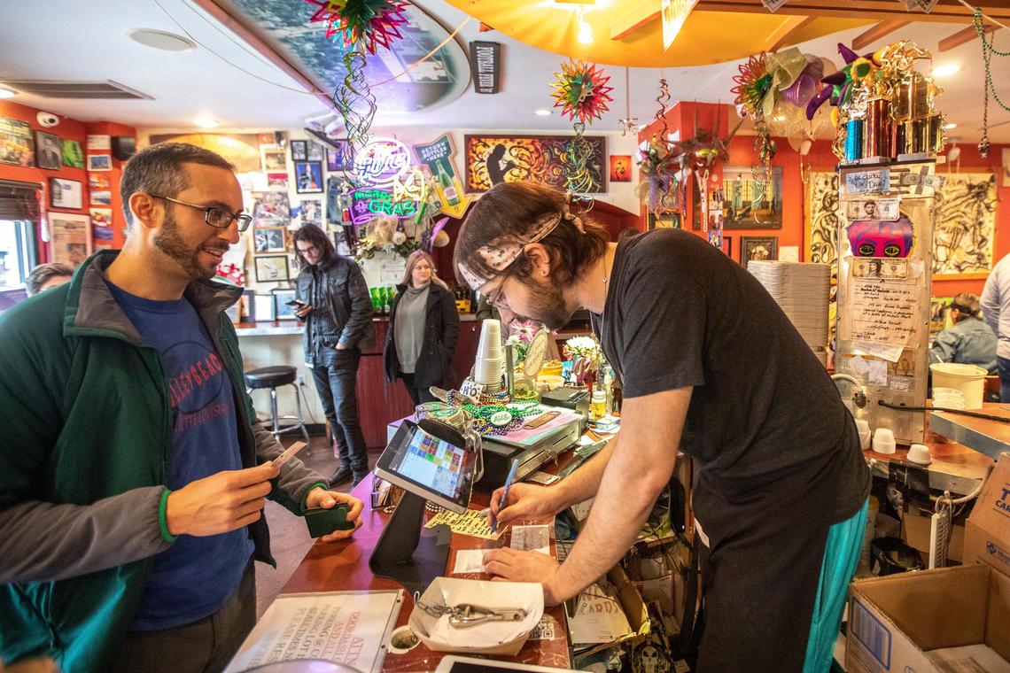 Marc Kai, of Lexington, places an order from Nick Lovin at Bourbon n’ Toulouse in Lexington, Ky., on Tuesday, Feb. 25, 2020.