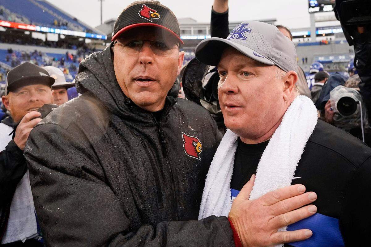 Louisville head coach Scott Satterfield, left, and Kentucky head coach Mark Stoops met at midfield after UK’s 45-13 victory over U of L in 2019. With SEC expansion raising the possibility the conference could go from eight to nine league games annually, there is some speculation about what that could mean for the future of the Governor’s Cup rivalry.