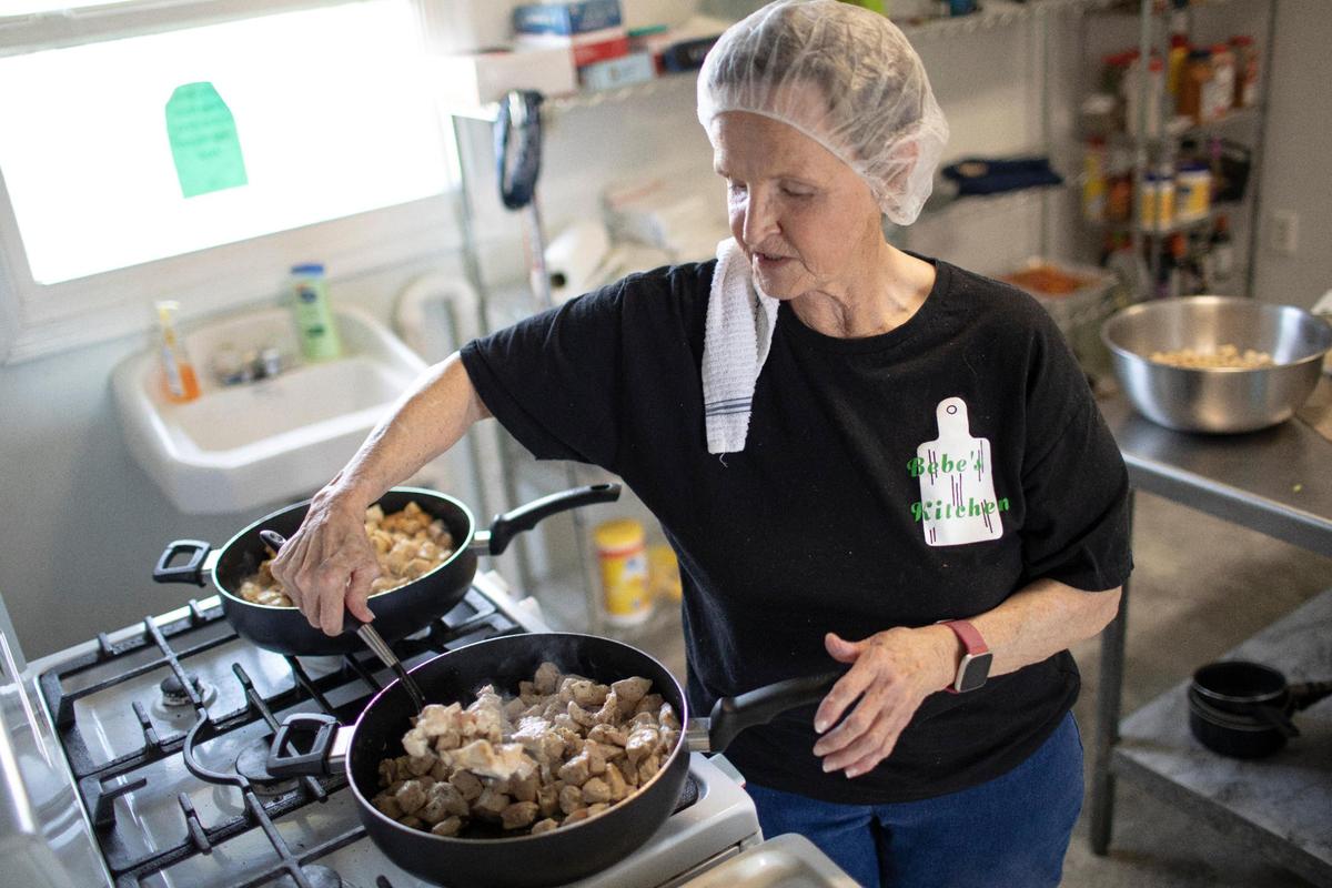 Bonnie Winfrey prepares dishes for her customers at her business, Bebe’s Kitchen, in Jeffersonville, Ky., Tuesday, March 16, 2021. Some of her most popular meals are stir-fry, meatloaf and chicken Alfredo.