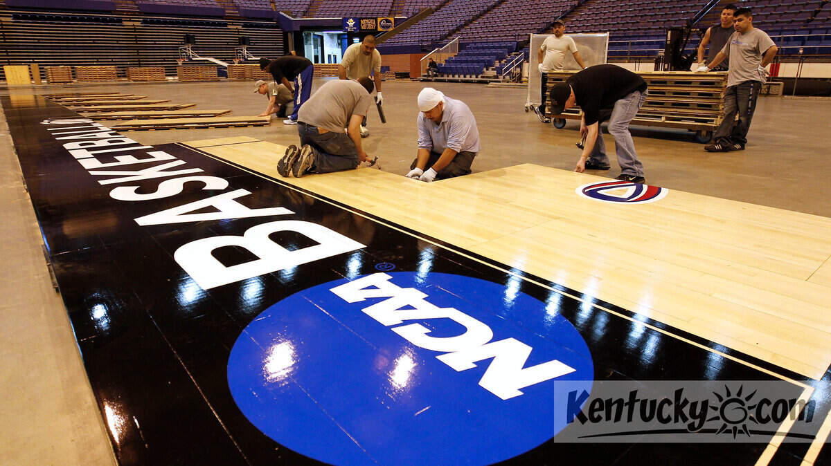 A crew put down the NCAA basketball floor in Rupp Arena on Monday. The floor was sent to Rupp Arena by the NCAA for rounds 2 and 3 of the tournament, which will be played in Rupp on Thursday and Saturday. Photo by Charles Bertram | Staff