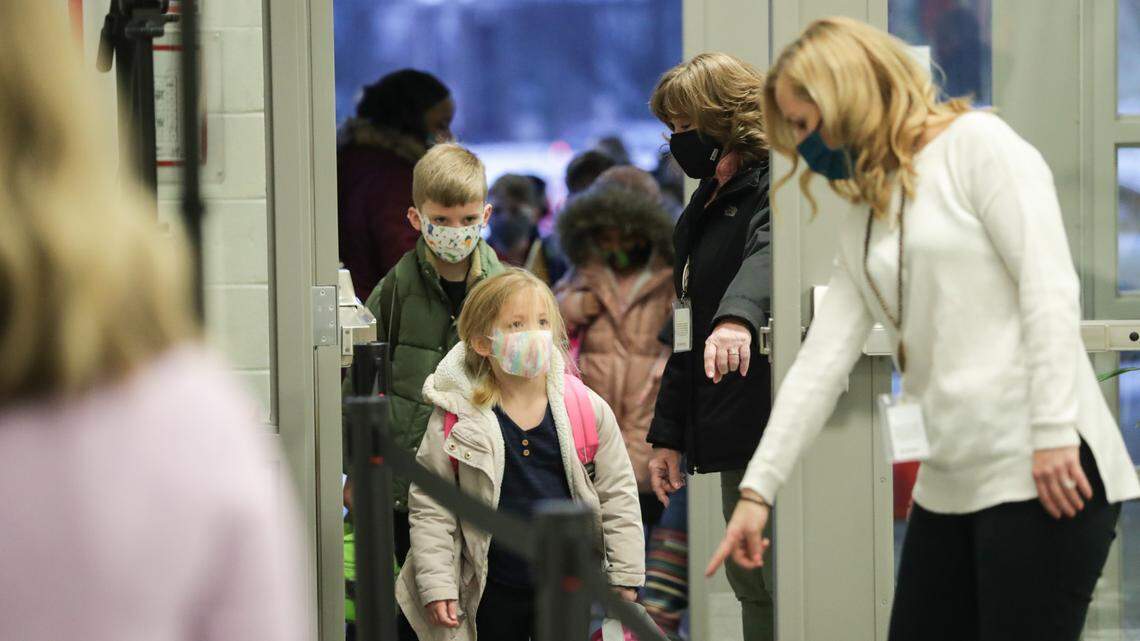 Students have their temperatures checked as they enter Veterans Park Elementary School on Monday, Feb. 22, 2021, for the first day of in-person classes this school year.