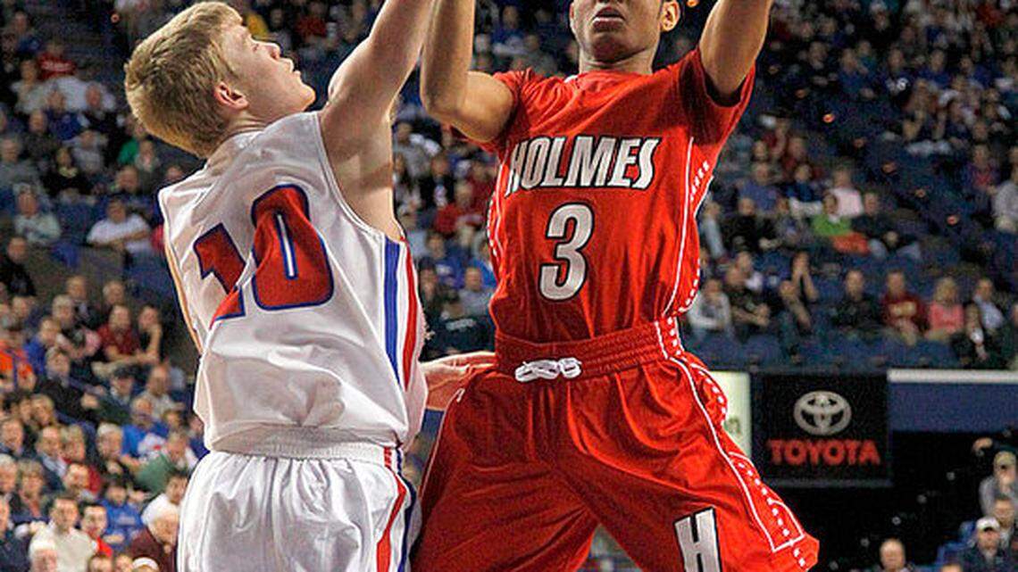 Holmes' James Bolden put up a jumper in the lane as Madison Central's Daniel Parke defended early in the game on Friday at the 2013 Boys' Sweet 16 at Rupp Arena. Photo by Mark Cornelison | Staff