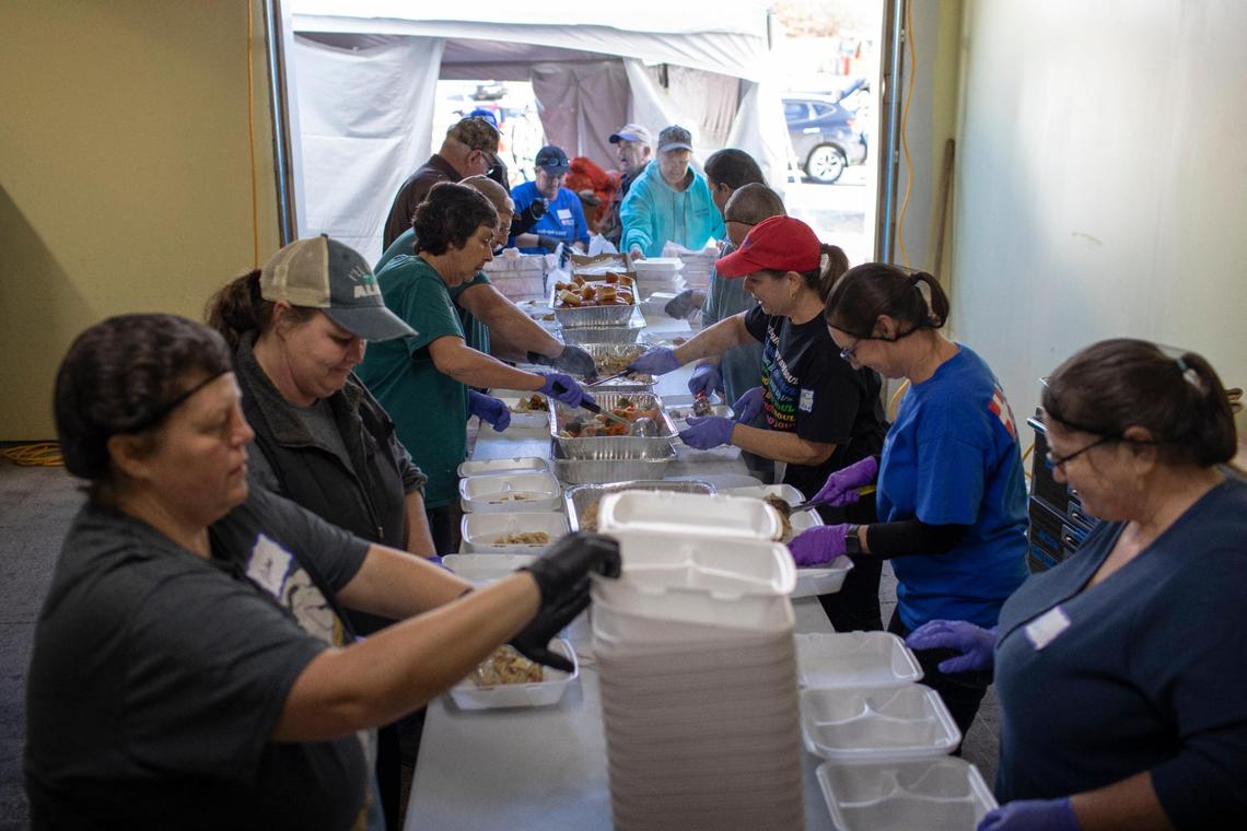 Volunteers with Mercy Chefs and the Hazel Green Food project work to serve hot meals, food supplies and water at The Hazel Green Food Project in Wolfe County, Ky., Thursday, January 19, 2023.