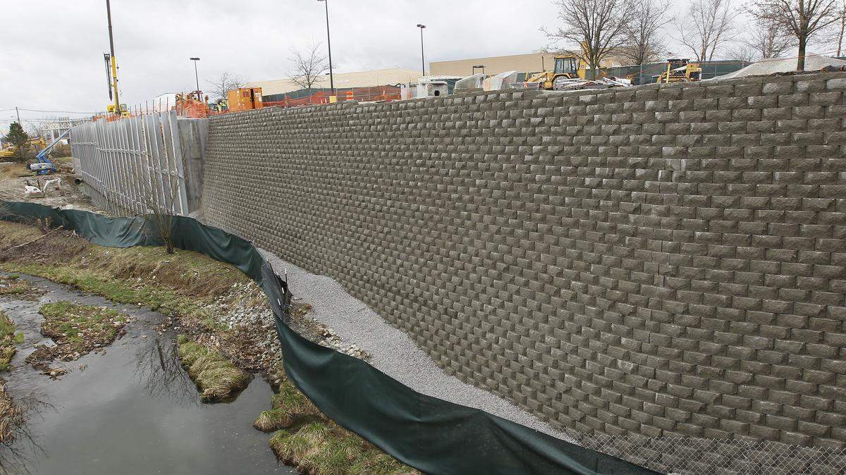 A section of the old wall, right, remains visible as the last phase of the project continues. 
