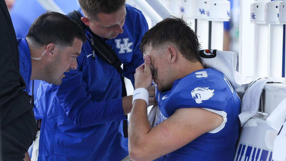 Injured Kentucky quarterback Zach Calzada (5) is consoled during the fourth quarter of Saturday’s loss to Ole Miss.