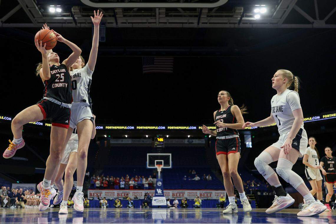 Taylor County’s Kennedy Deener (25) goes up for a layup against Notre Dame’s Sarah Young (10) during the Clark’s Pump-N-Shop Girls’ Basketball Sweet 16 quarterfinals at Rupp Arena on Friday.