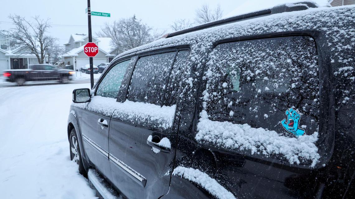 A truck drives through the intersection of Iron Lace and Pleasant Ridge Drive Friday, Jan. 10, 2025 in Lexington, Ky while another is parked on the side of the road. A second winter storm in five days dumped 3.1 more inches of snow on Lexington Friday and early Saturday after the area was hit with inches of snow earlier.
