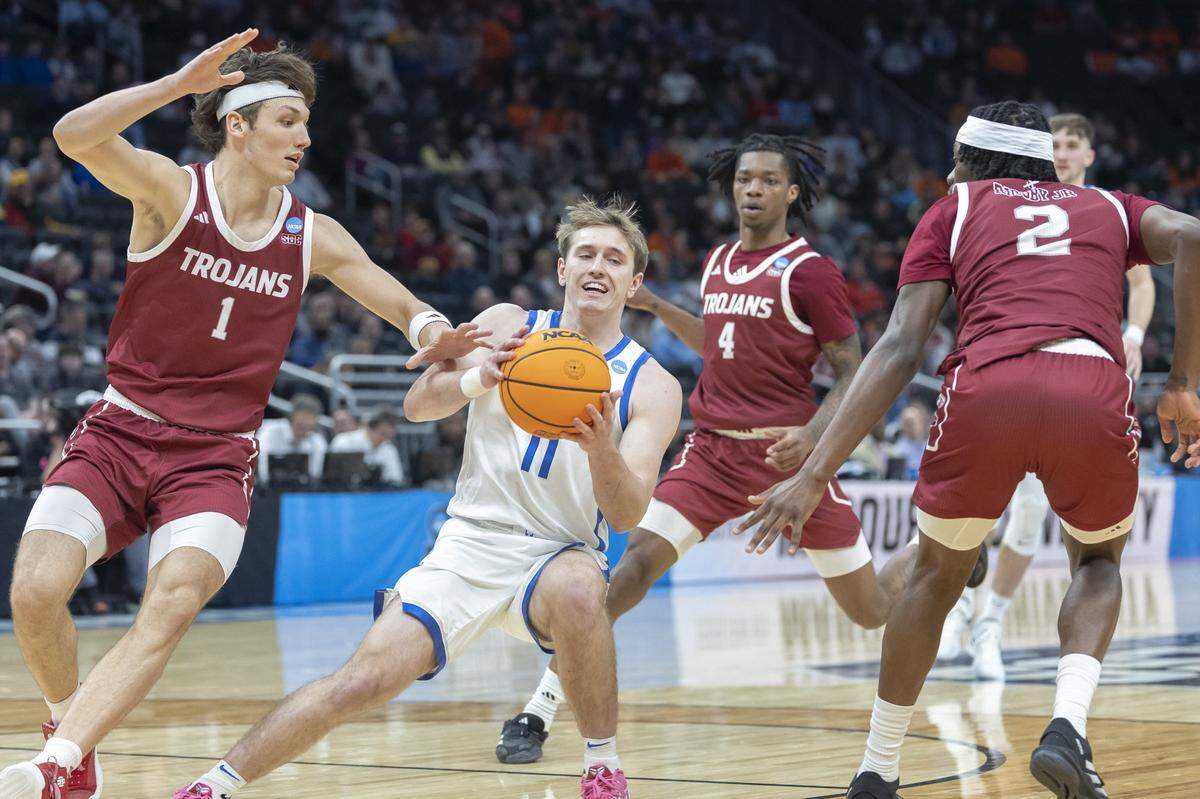 Kentucky guard Travis Perry (11) drives the ball as Troy forward Thomas Dowd (1) defends during a first-round NCAA Tournament game at Fiserv Forum in Milwaukee on Friday.