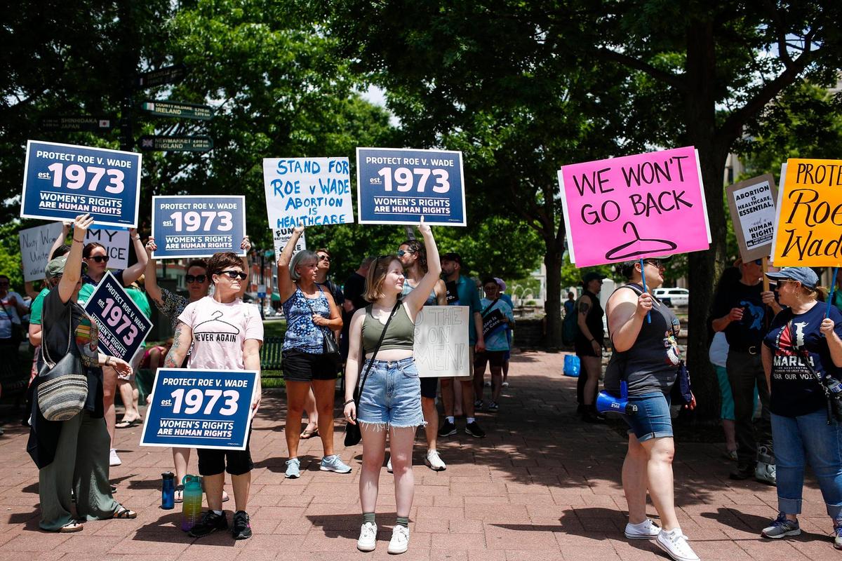 Protesters cheer and gather outside the courthouse during the Rise Up 4 Abortion Rights protest in downtown Lexington, Ky., Saturday, May 14, 2022.