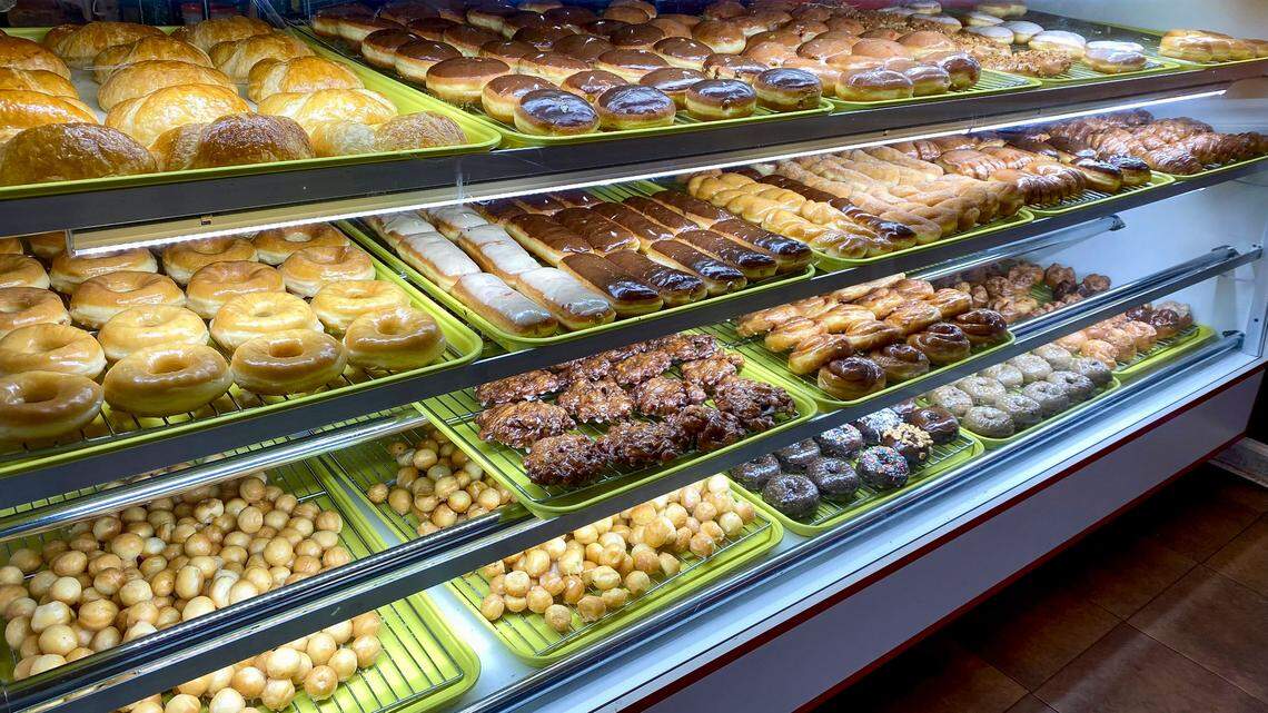 The doughnut case at OMG Donuts in Lexington, Ky, May 24, 2022 displays glazed, long john’s cake and other types of breakfast treats.