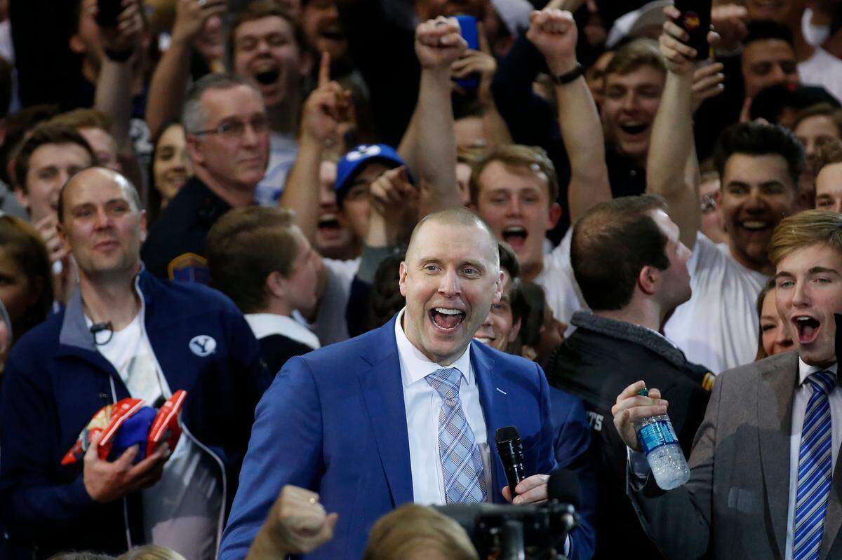 BYU Coach Mark Pope celebrated with fans after the Cougars upset No. 2 Gonzaga 91-78 Saturday night.
