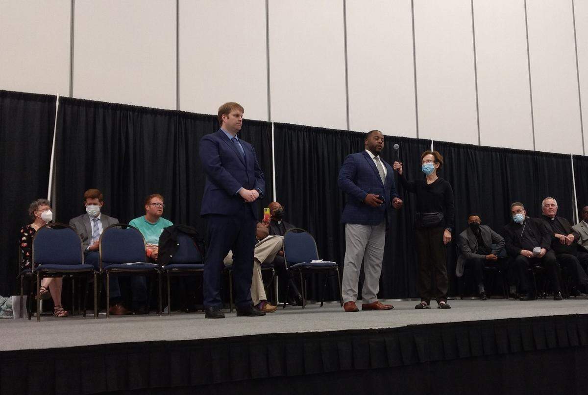 Lexington mayoral candidates David Kloiber, left, and Adrian Wallace, at mic, said they support BUILD’s calls for Lexington to implement the National Network for Safe Communities’ Group Violence Intervention program.