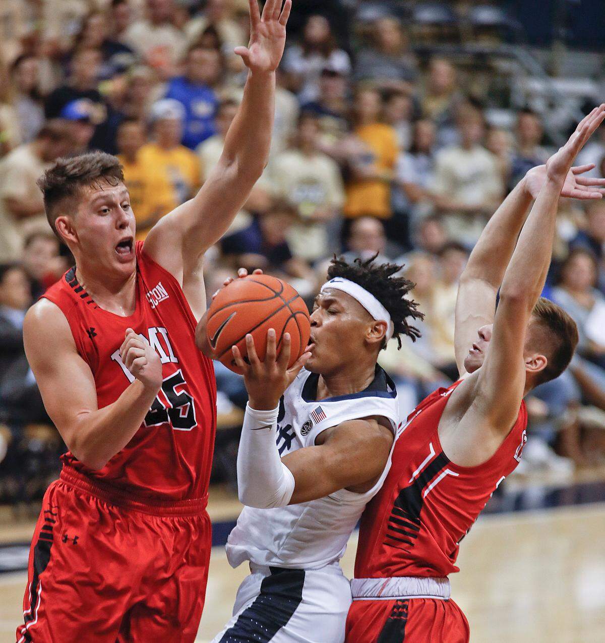 VMI’s Tyler Creammer, left, and Garrett Gilkerson, right, tried to cut off a drive by Pittsburgh’s Au’Diese Toney during their game in Pittsburgh on Nov. 9. Pittsburgh won 94-55.