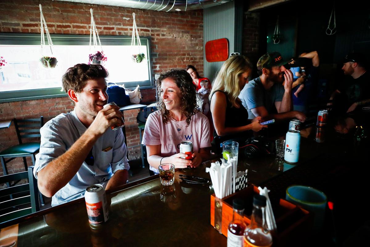 Erin Hathaway jokes with Paul Masterson at Al’s Bar in the northside neighborhood. The dive bar’s hours are scaled back to a long weekend schedule from Thursday through Sunday but will be expand to seven days a week soon.