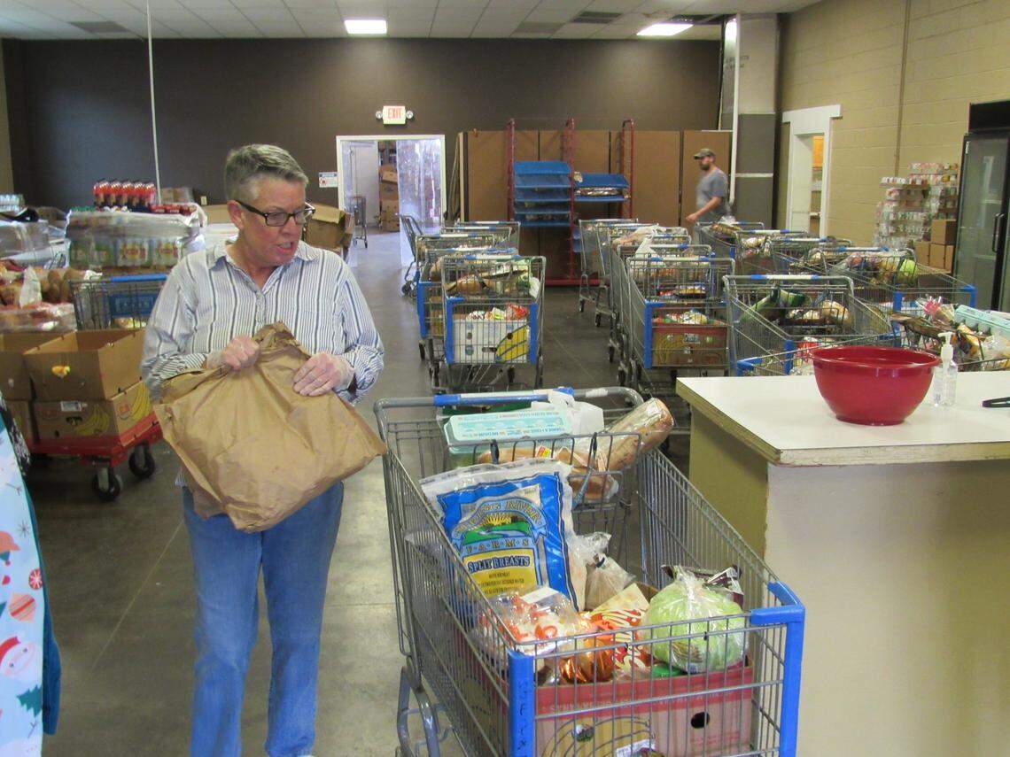 Sherry Simpson, a volunteer at God’s Food Pantry in Somerset, Ky., filled a cart with food to be given away on March 23, 2020.