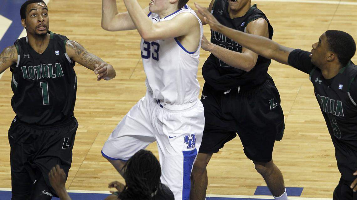 Surrounded by, from left, Loyola's Anthony Winbush, R.J. Williams, Erik Etherly and Shane Walker, Kyle Wiltjer grabbed a rebound during the second half. He was the game's leading scorer with 24.    