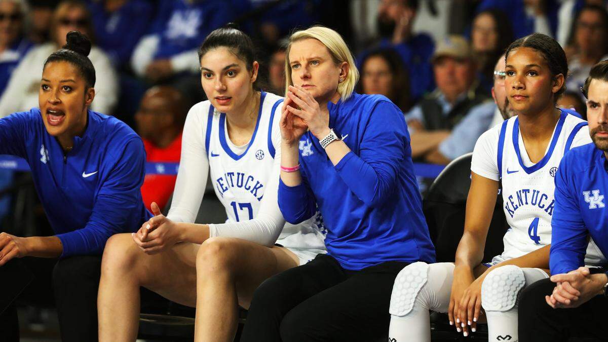Clara Silva (17), Kentucky’s 6-foot-7 freshman sensation from Portugal, watches from the bench with assistant coach Radvile Autukaite during Saturday’s game. Silva went scoreless in eight early minutes as UK’s more experienced starters handled the majority of the load against perennial power Louisville.
