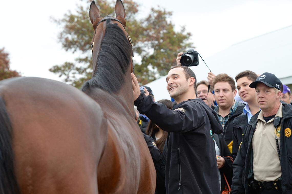 Justin Zayat gave American Pharoah a pat on the neck on the backside as race fans came to greet the Breeders Cup Classic champion in 2015.
