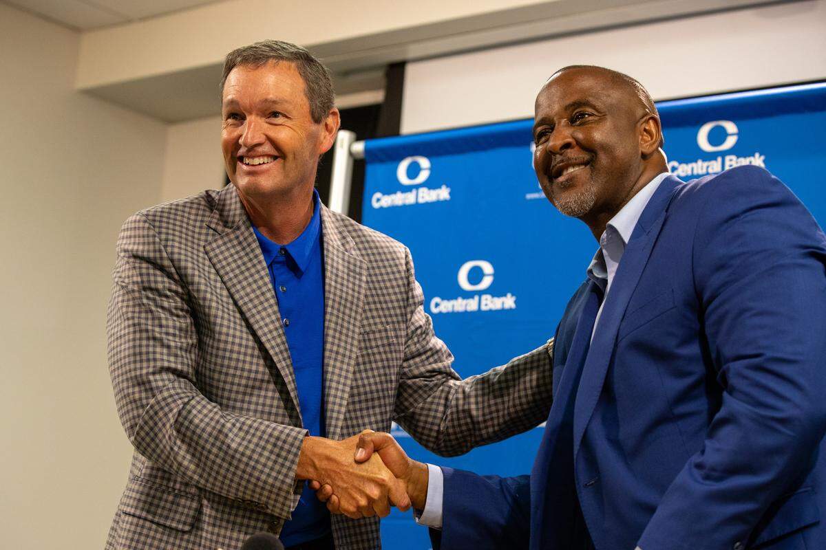 Kentucky Athletics Director Mitch Barnhart, left, posed with Lonnie Greene during Tuesday's introductory news conference for UK's new track and field head coach at Kroger Field.