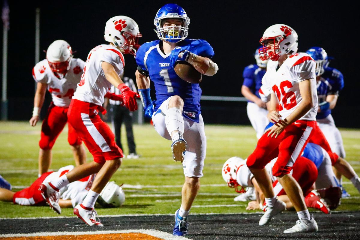 Paintsville’s John Walker Phelps (1) high steps through Beechwood’s Brady Moore (6) and Avery Courtney (26) for a touchdown that cut the Beechwood lead to 14-13 Friday night in their game at Toyota Stadium in Georgetown, Ky., Friday, Aug. 30, 2019. Paintsville beat Beechwood 19-14.