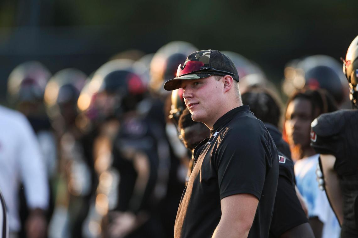 Paul Laurence Dunbar’s Ethan Hampton looked on from the sidelines as the Bulldogs prepared to play Tates Creek at home on Sept. 29. A spinal cord injury ended his playing career this season, but he’s since taken on the role of student coach for his team.