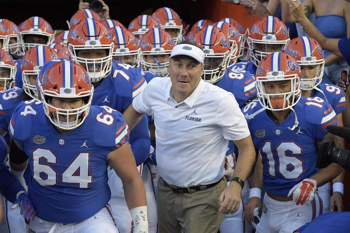 After going 8-1 against Kentucky as Mississippi State head coach, Dan Mullen, center, is 2-1 vs. the Wildcats as Florida head man.