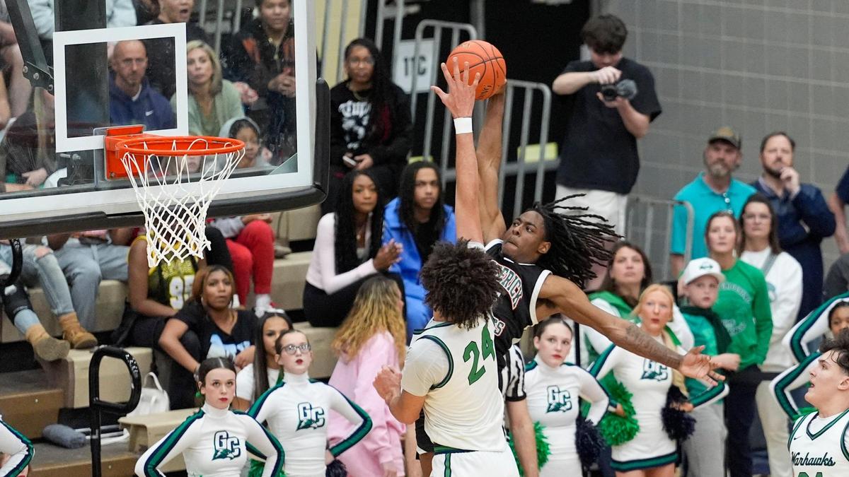 Great Crossing’s Malachi Moreno (24) blocks Frederick Douglass’ Aveion Chenault (10) during the Warhawks’ 59-57 win in the 11th Region Tournament championship game.