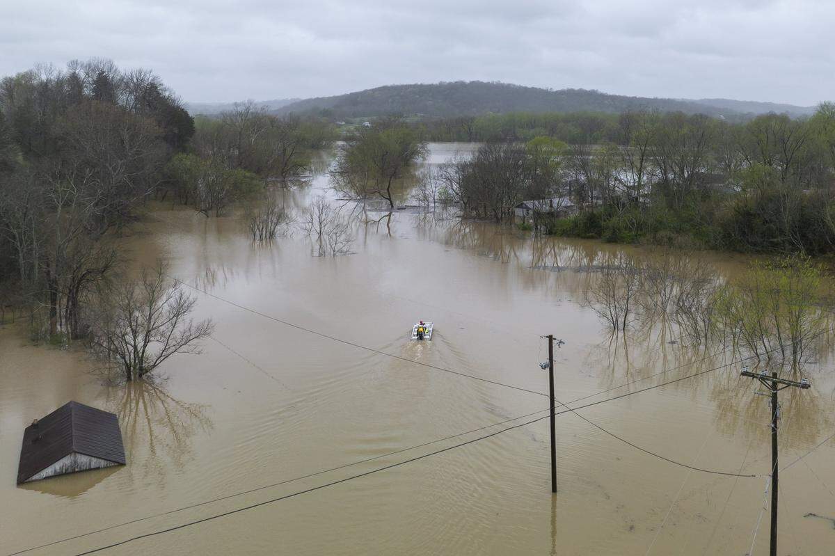 An Owen County Search and Rescue vessel passes by the flooded community of Monterey, Ky., on Sunday, April 6, 2025.