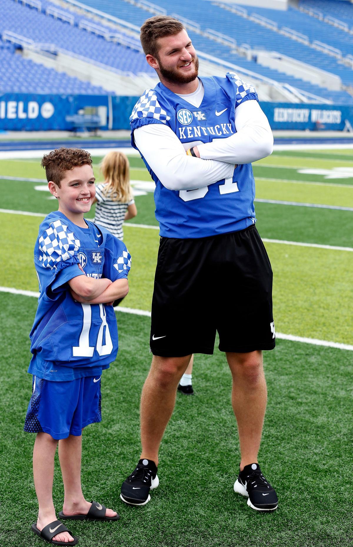 Luke Klausing, an 11-year-old boy from Louisville with cystic fibrosis, posed with player C.J. Conrad after had  a “signing day” ceremony Wednesday morning to join UK’s football team for the season.