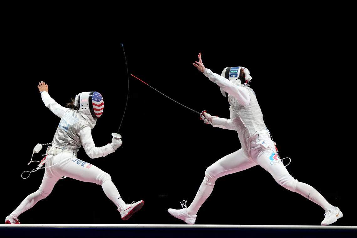 Lee Kiefer, left, celebrated winning the women’s individual foil gold medal match against Inna Deriglazova of the Russian Olympic Committee at the Summer Olympics on Sunday in Chiba, Japan.