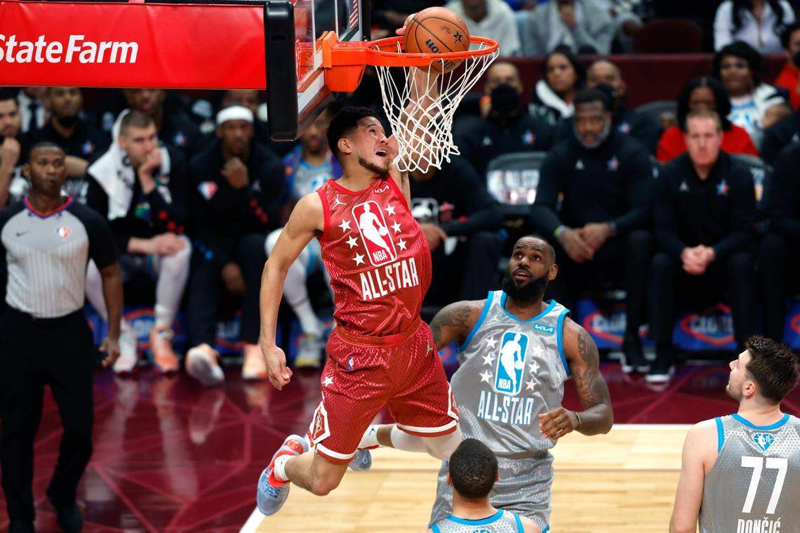 The Suns’ Devin Booker dunks against the Lakers’ LeBron James during the second half of the NBA All-Star Game on Feb. 20 in Cleveland.