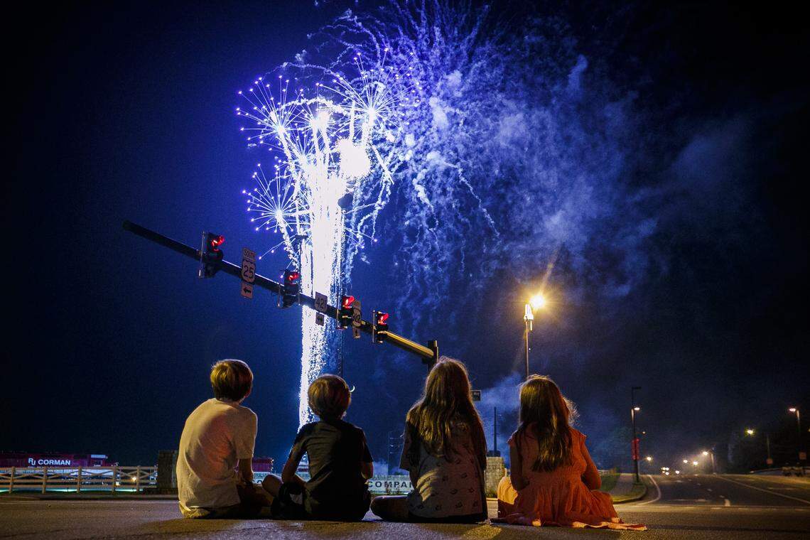 Oliver Bennett, 14, from left, Levi Burnett, 9, Leah Burnett, 13, and Audrey Bennett, 11, all of Lexington, Ky., watch the city of Lexington’s Fourth of July fireworks display from the intersection of Main Street Oliver Lewis Way in Lexington Thursday, July 4, 2019. Fireworks were launched from the R.J. Corman Railyard.