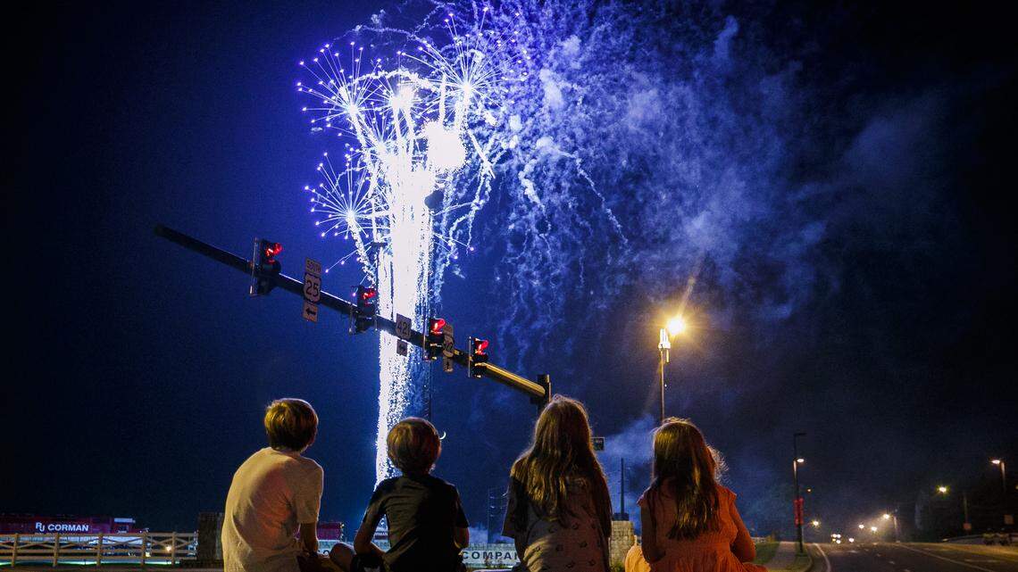 Oliver Bennett, 14, from left, Levi Burnett, 9, Leah Burnett, 13, and Audrey Bennett, 11, all of Lexington, Ky., watch the city of Lexington’s Fourth of July fireworks display from the intersection of Main Street Oliver Lewis Way in Lexington Thursday, July 4, 2019. Fireworks were launched from the R.J. Corman Railyard.