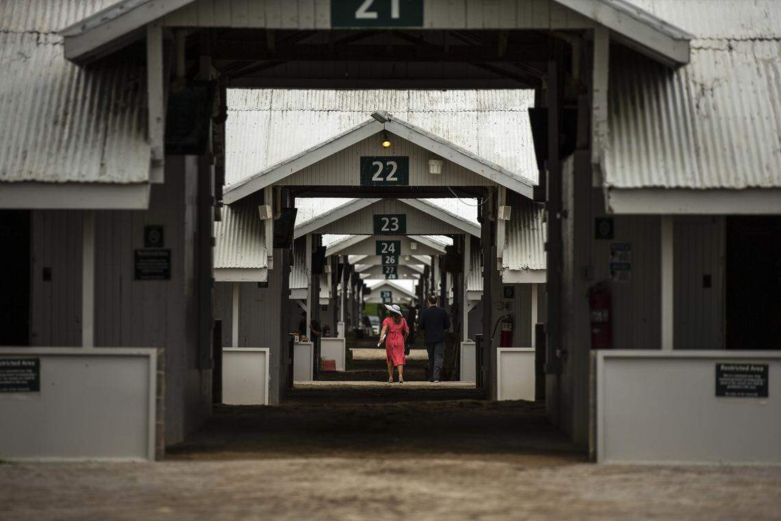 Fatima Leach and Cody Bostic, coworkers from Indianapolis, Ind., walk through the barns at Keeneland on Thursday, April 25, 2019.