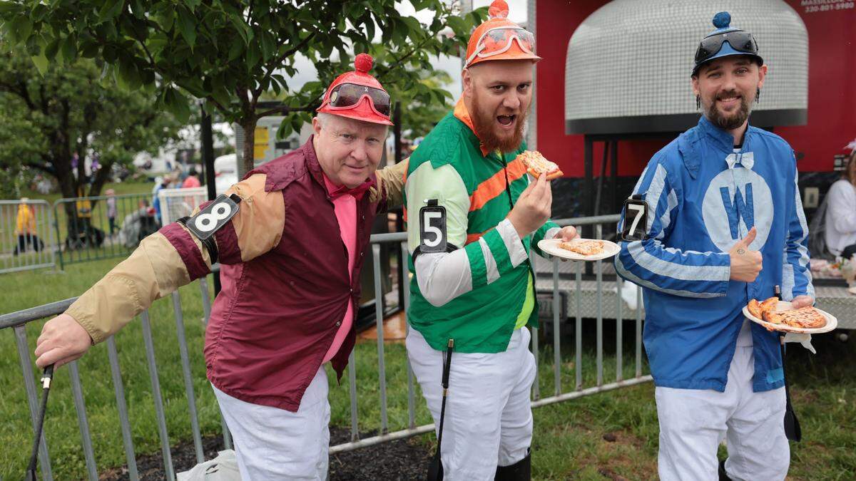Three friends — from left, Michael Freeze, Curtis Paplik and John James — dressed as jockeys in the infield for the 151st Kentucky Derby, held May 3, 2025, at Churchill Downs in Louisville, Kentucky. The trio have combined for more than 20 visits to the Run For The Roses.