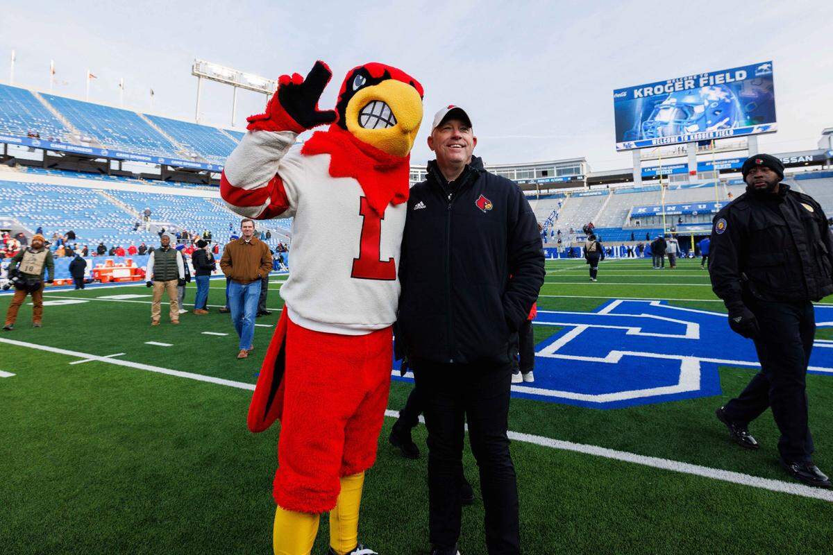 Louisville coach Jeff Brohm posed for a photo with the Cardinal mascot after U of L snapped a five-game losing streak vs. Kentucky with a 41-14 win at Kroger Field.