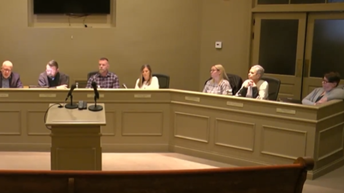 Abigail Miller (right) will keep her city council seat after she was accused of licking a city administrator’s hand.