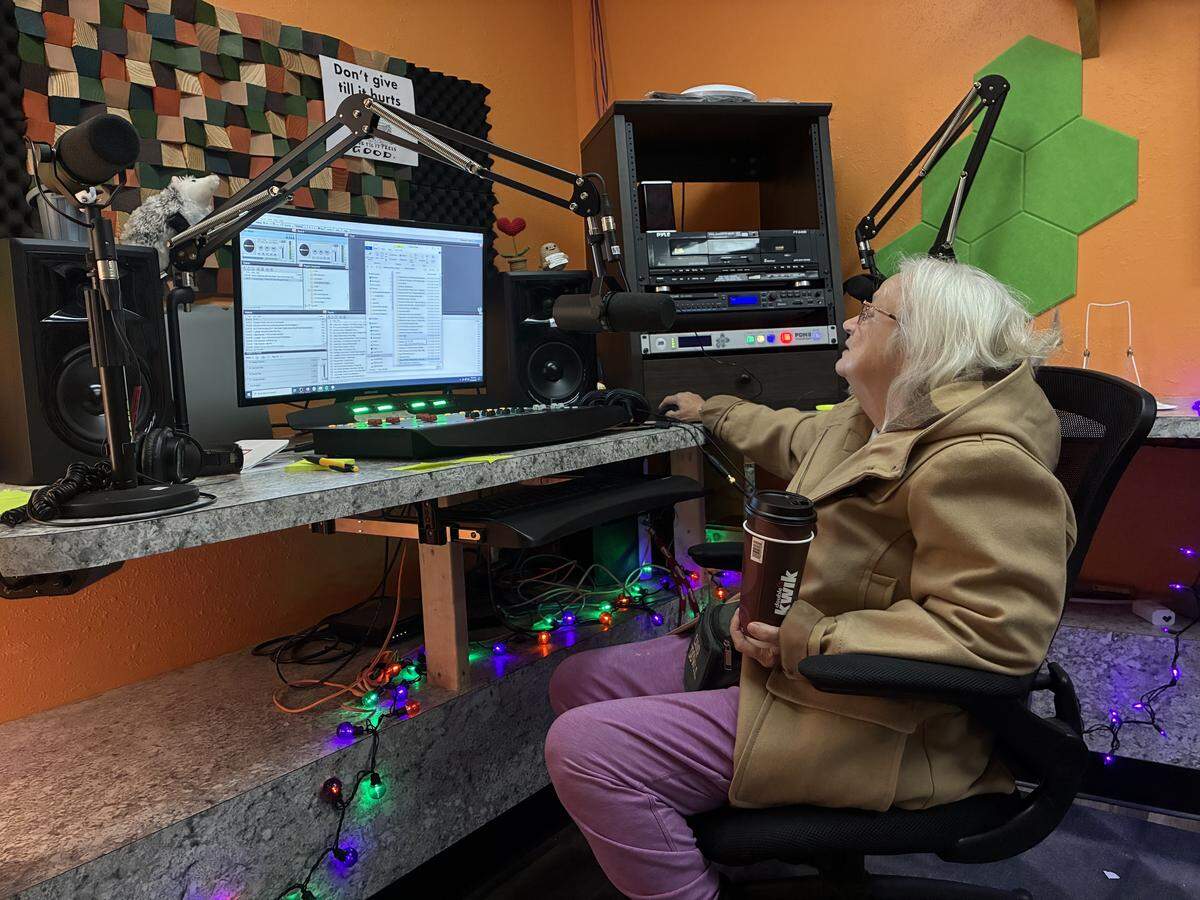 Zelma Forbes, whose DJ name is Sweet Tater, selects music to play at WMMT 88.7 FM’s studios in downtown Whitesburg, KY, on Nov. 14, 2025.
