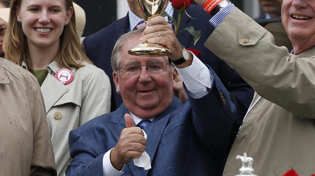Orb trainer Shug McGaughey raised the trophy after Orb with Joel Rosario up won 139th running of the Kentucky Derby on Saturday  May 4, 2013 at Churchill Downs in Louisville, Ky. Photo by Mark Cornelison | Staff