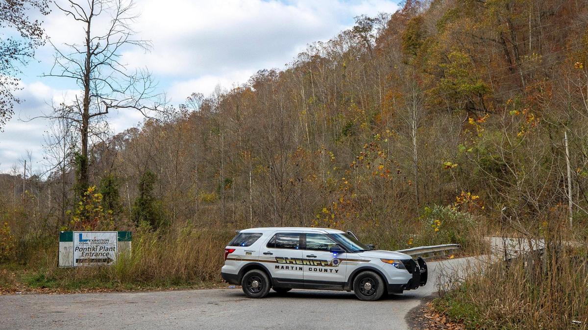 A sheriff’s vehicle blocks a road leading to the area where a rescue operation is underway for two workers trapped inside a collapsed coal preparation plant in Martin County, Ky., on Wednesday, Nov. 1, 2023.