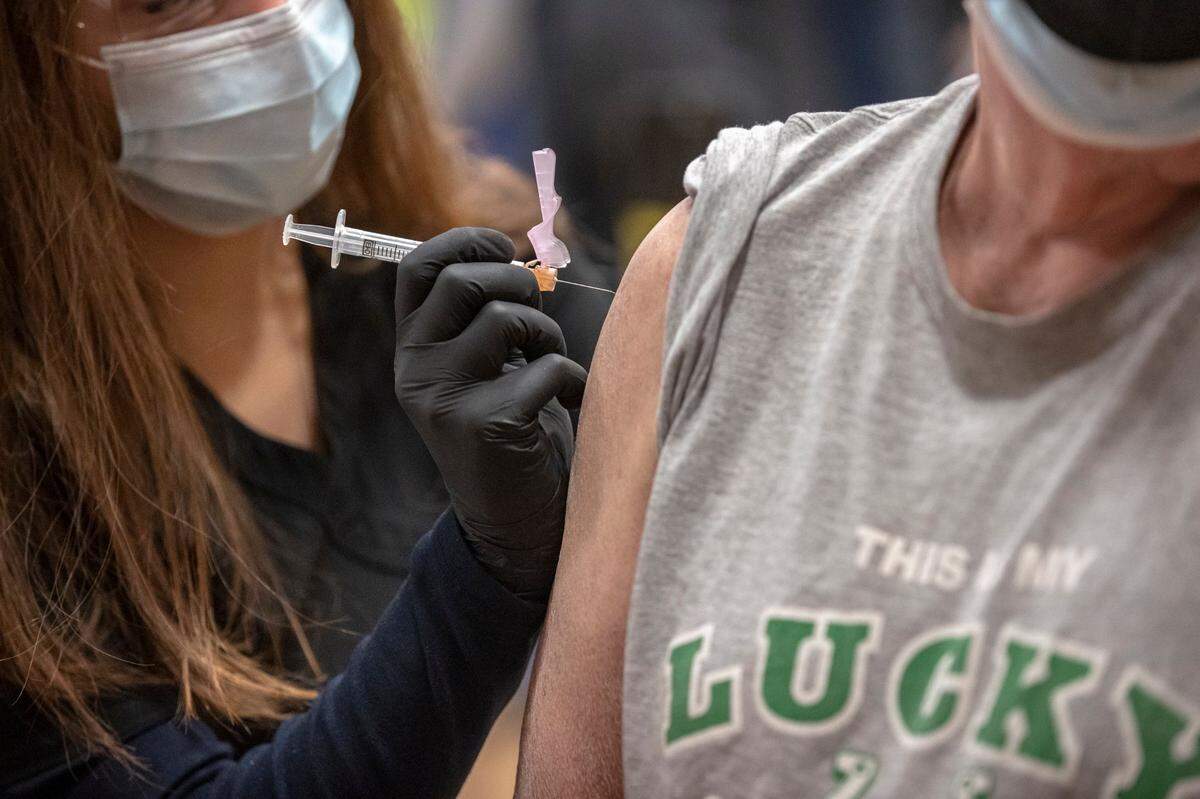 Christine Said administers the COVID-19 vaccine to Robert Moyer, of Lexington, during a 2021 Lexington-Fayette County Health Department vaccination clinic at Consolidated Baptist Church.